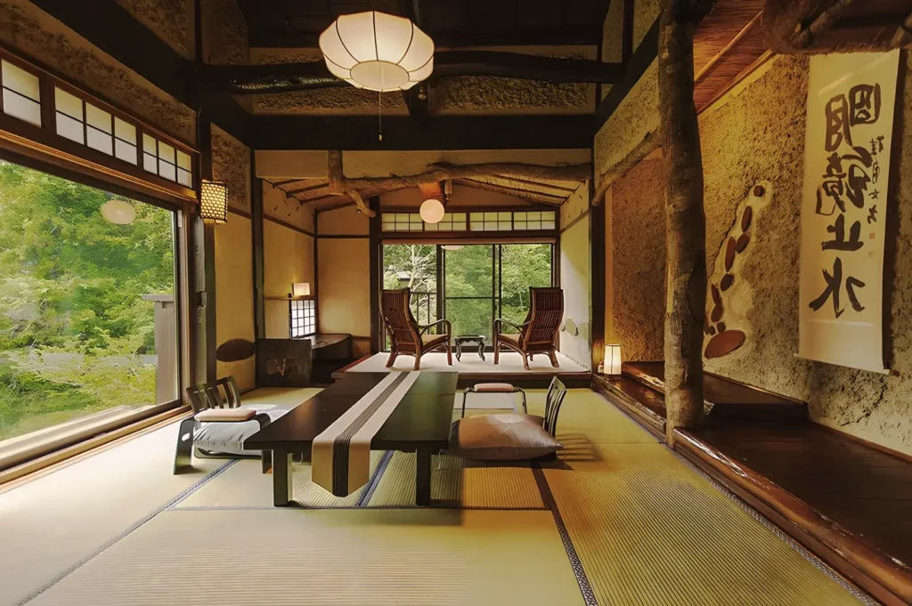 Rustic Japanese tatami room with low dining table, calligraphy scroll, and forest view, featuring authentic wooden beams and shoji doors.